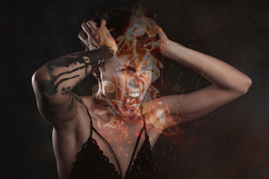 Woman wearing a skimpy outfit burning in hell