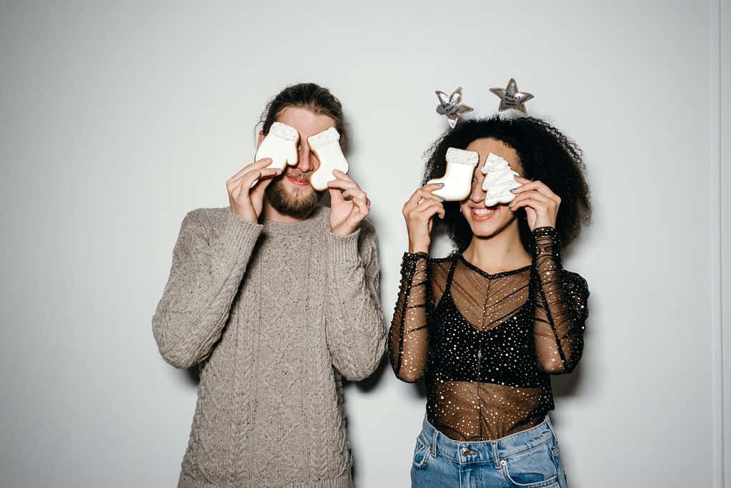 A couple covering their eyes with sugar cookies: Churchianity ignoring the scriptures/bible.