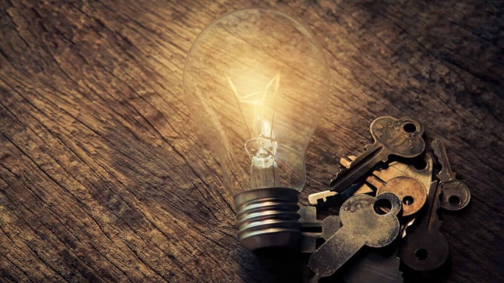 Light Bulb and Keys on Table